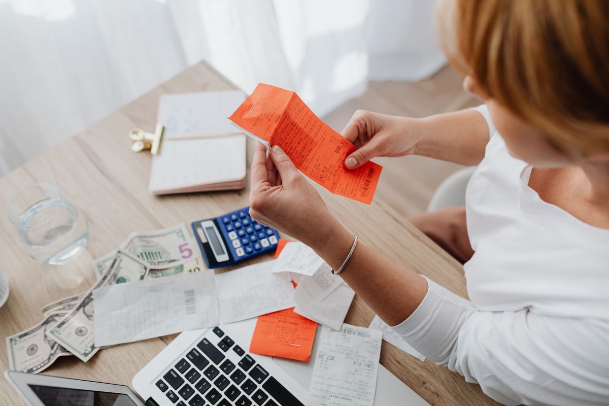 Business owner sorting invoices and receipts on their desk